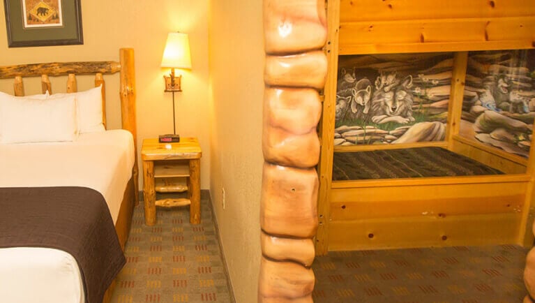 The bed and indoor cabin with bunk beds in the accessible Wolf Den Suite at Great Wolf Lodge NIagara Falls, ON.